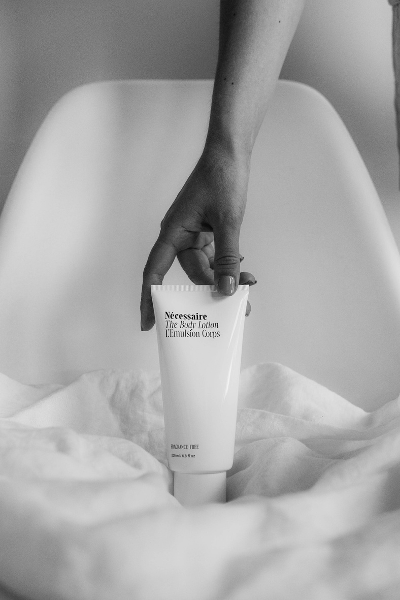 Person Holding White Plastic Tube Bottle